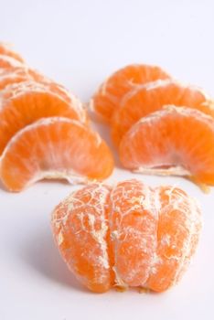 Juicy tangerine covered by drops of water. Over white background