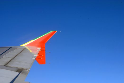 clear sky with airplane wings detail.