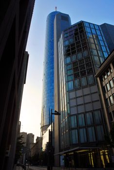 Golden and blue skyscraper reflecting a blue sky. Frankfurt, Germany.