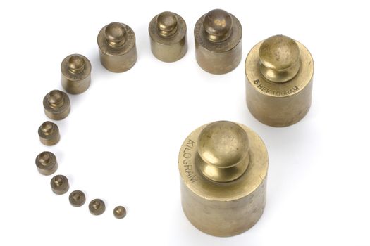 brass weights on white background