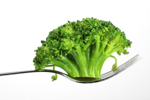 broccoli on a fork over white background