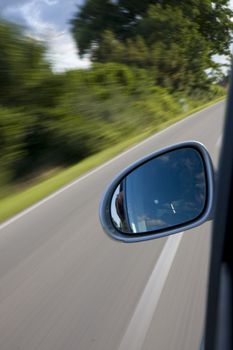 detail of a car driving on a country road