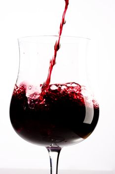 red wine splashing in a glass