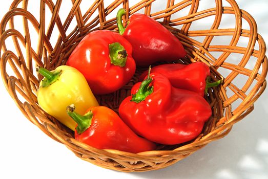 red and yellow pepper in wooden basket 