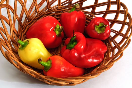 red and yellow pepper in wooden basket 