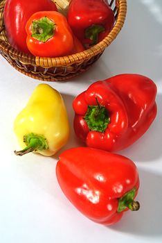 red and yellow pepper in wooden basket 