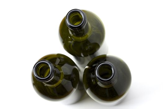 three wine bottles seen from top on white background