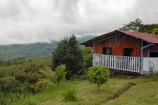 Wooden house in a valley under a cloudy sky. Central Panama
