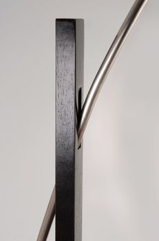 Metallic and wooden contemporary floor lamp detail.  Isolated object