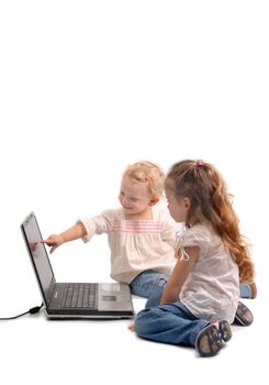 Little girl and baby sister touching a notebook screen on white background