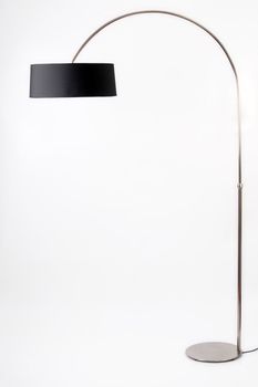 Contemporary metallic and black floor lamp on white background