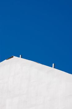 white wintage wall against the deep blue sky