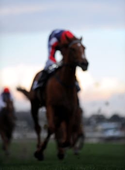 A dreamy thoroughbred Race horse coming to the finish during a race. 