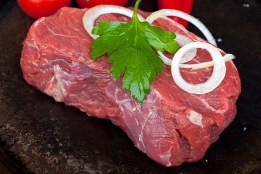 raw beef steak in a iron pan