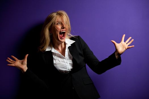 screaming business woman on a purple wall