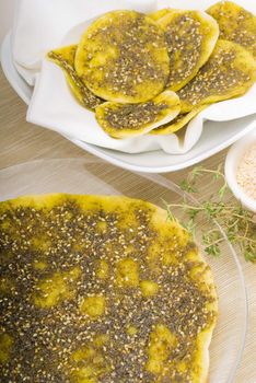 lebanese manouche or manoushe ,lebanese pizza with thyme and sesame seeds,zaatar, and extra virgin olive oil on top