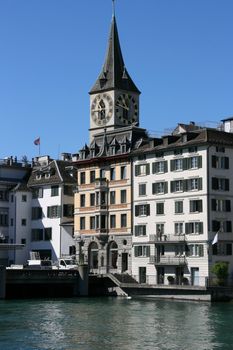 Zurich cityscape. St. Peter's Church tower with world's largest church clock face. Swiss city.