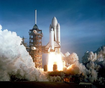 The April 12th 1982 launch at Pad 39A of STS-1, just seconds past 7 a.m., carries astronauts John Young and Robert Crippen into an Earth orbital mission scheduled to last for 54 hours, ending with unpowered landing at Edwards Air Force Base in California. ** Credit: NASA / yaymicro.com **