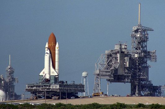 The Space Shuttle Endeavour is being rolled around from Launch Pad 39A to Launch Pad 39B. The rare pad switch was deemed necessary after contamination was discovered in the Payload Changeout Room at Pad A. The transfer began around noon and was completed about seven hours later. Still to come are the payloads for the upcoming STS-61 mission, the first servicing of the Hubble Space Telescope. Photo taken: 11/15/1993. ** Credit: NASA / yaymicro.com **