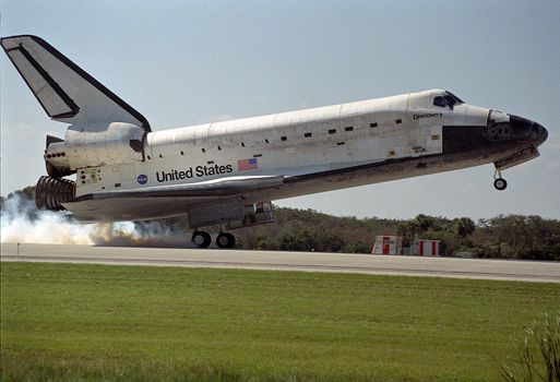 Orbiter Discovery is riding on its main landing gear as it lowers its nose wheel after touching down on Runway 33 at the Shuttle Landing Facility. Main gear touchdown was at 12:04 p.m. EST, landing on orbit 135. Discovery returns to Earth with its crew of seven after successfully completing mission STS-95, lasting nearly nine days and 3.6 million miles. The crew includes mission commander Curtis L. Brown, Jr.; pilot Steven W. Lindsey, mission specialists Scott E. Parazynski, Stephen K. Robinson, with the European Space Agency (ESA); payload specialist Chiaki Mukai, with the National Space Development Agency of Japan (NASDA); and payload specialist John H. Glenn, Jr., a senator from Ohio and one of the original seven Project Mercury astronauts. Photo taken: 11/7/1998. ** Credit: NASA / yaymicro.com **