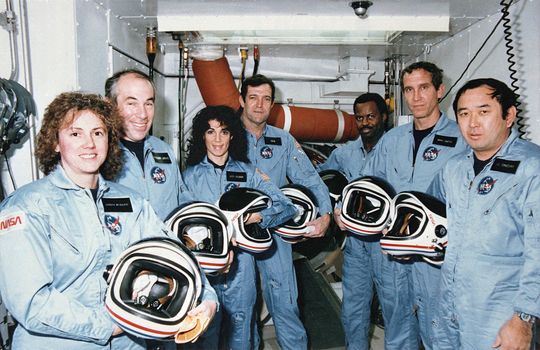 Crew members of mission STS-51L stand in the White Room at Pad 39B following the end of the Terminal Countdown Demonstration Test (TCDT). From left to right they are: Teacher in Space Participant, Sharon "Christa" McAuliffe, Payload Specialist, Gregory Jarvis, Mission Specialist, Judy Resnik, Commander Dick Scobee Mission Specialist, Ronald McNair, Pilot, Michael Smith and Mission Specialist, Ellison Onizuka. ** Credit: NASA / yaymicro.com **