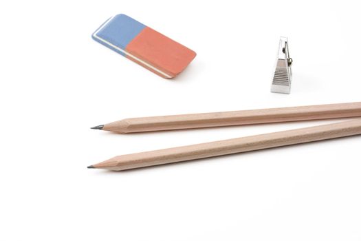 a pen, a sharpener and an eraser