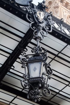 A old looking lantern hanging from a ceiling