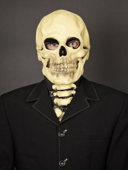 Portrait of a man in a mask of death on a black background