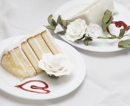 two pieces of a wedding cake on different plates