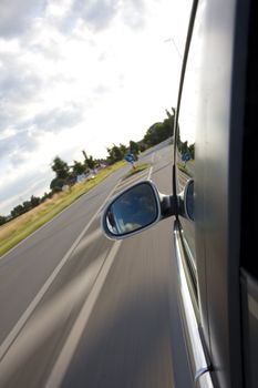 detail of a car driving on a country road