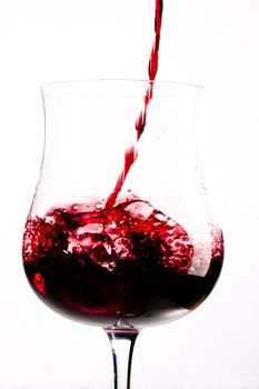 red wine splashing in a glass