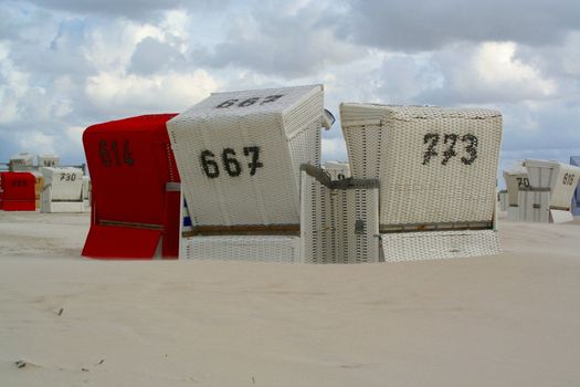 three beach chairs on the shore of St. Peter-Ording