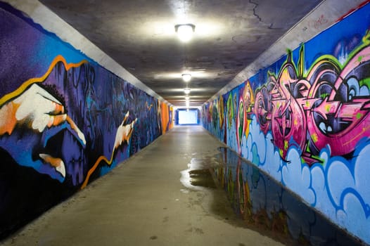 Underground tunnel with graffiti painted walls