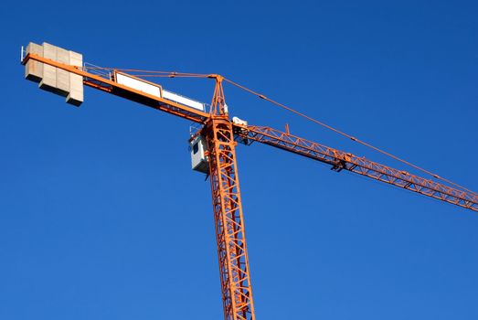 Construction crane on a blue sky background