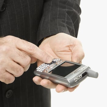 Close-up of Caucasian middle-aged businessman using handheld PDA.