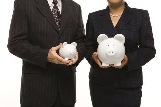 Caucasian middle-aged businessman and Filipino businesswoman holding different sized piggybanks.