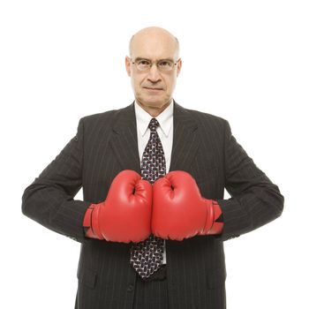 Caucasian middle-aged businessman wearing boxing gloves.