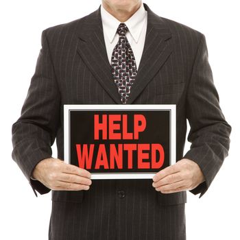 Caucasian middle-aged businessman holding help wanted sign.