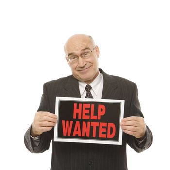 Caucasian middle-aged businessman holding help wanted sign.