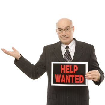 Caucasian middle-aged businessman holding help wanted sign.