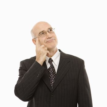 Caucasian middle-aged businessman with hand to head looking thoughtful standing against white background.