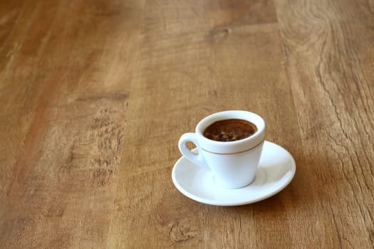 a cup of coffee on wood floor