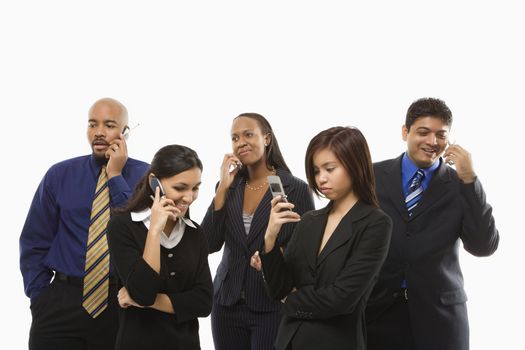 Multi-ethnic business group of men and women standing talking on cell phones.