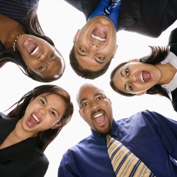 Low angle portrait of multi-ethnic business group of men and women in huddle screaming.