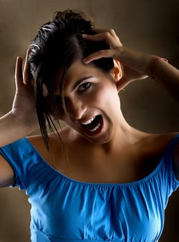 Woman yelling with hands on the head