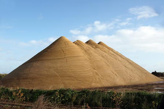 Looks almost as if we have pyramids in Denmark, too. I saw these huge gravel heaps at a pit side, and couldn't resist the very beautiful structure from millions of years old sediments reflecting in the sunshine. Very fine picture for illustrating books or articles about the basic raw materials for a lot of industries, road building, and for geography etc. or just as a poster for home decoration.