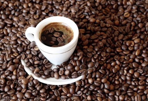 a cup with coffee in background