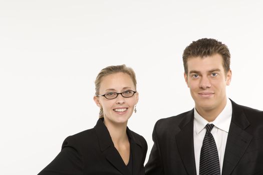 Portrait of Caucasian mid-adult businessman and woman smiling and looking at viewer.