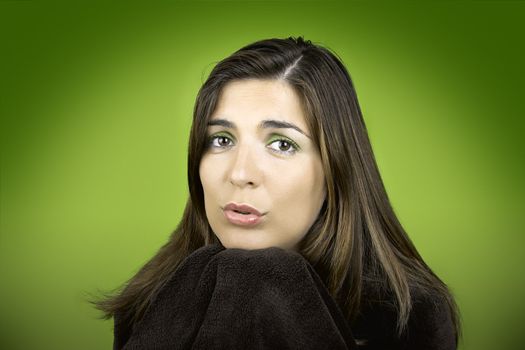 Beautiful woman with a cute face covering itself with a blanket