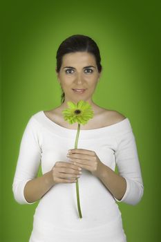 Beautiful woman with flowers on a green background